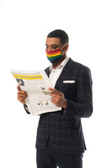 african american businessman in lgbt colors medical mask reading newspaper isolated on white