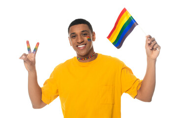 happy african american man holding lgbt flag and showing victory sign isolated on white