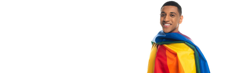 young african american man, covered with lgbt flag, smiling at camera isolated on white, banner