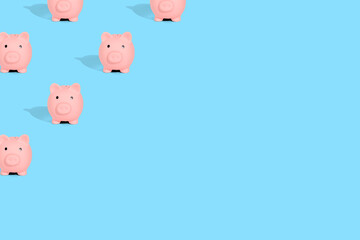 . Pattern of pink piggy banks on a blue background. Financial savings concept