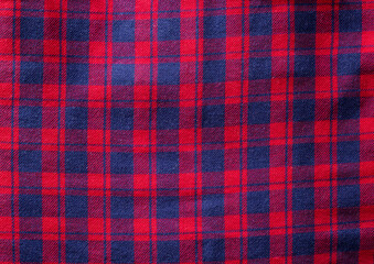 Red checkered material on clothes shirt, background. Macro, texture