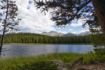 Bierstadt Lake with blue sky and white clouds in background in Rocky Mountain National Park, Colorado