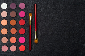 set of colorful eye shadows with brushes