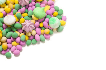 Colorful meringues and glazed peanuts isolated on a white background.