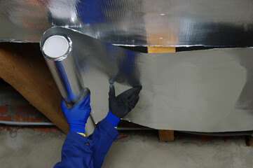 Builder attaches vapor barrier membrane