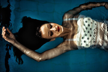 Female model posing in a pool