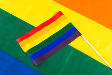 top view of small lgbt flag on rainbow colors background