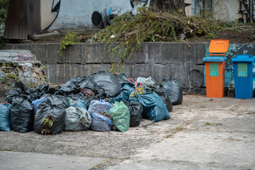 bunch of full plastic garbage bags after city clean up