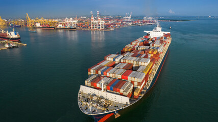 Aerial in front of smart cargo ship carrying container and running near international custom sea...