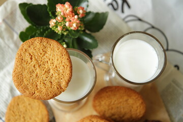 Almond cookies with nuts on a wood plank. cup of milk