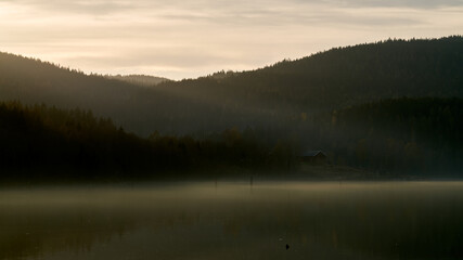 Springtime at the lake. Fog, mist and sun rays.