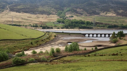 A landscape of a aqueduct and a reservoir 