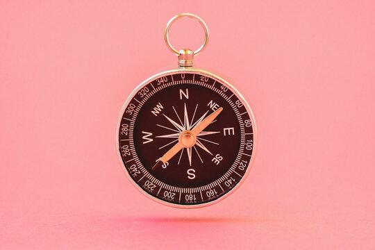 Compass floating on the pink background