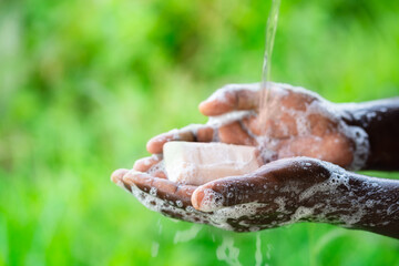 African man washing hands with soap.Hygiene concept