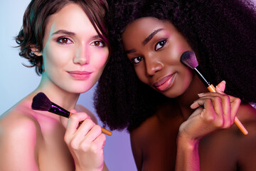 Photo of two pretty adorable people hold brush applying tome cosmetics pure aesthetic isolated on...