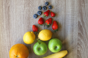 Various colorful fruit on wooden background. Flat lay.