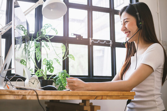 Asian Young High School Student Woman Is Studying,learning Academic Lesson Online Wearing Headset,earphone Or Headphone And Looking At The Laptop Computer At Home. Education In Pandemic Covid Concept.