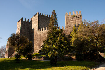 Naklejka premium The 10th Century Guimaraes Castle (Castelo de Guimaraes) in Guimaraes Portugal, considered the most famous castle in the country 