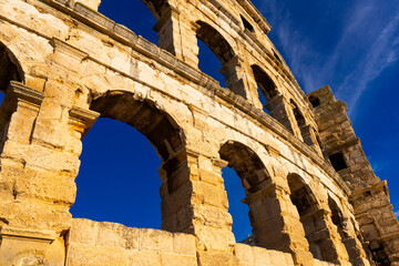 Sunny weather. The walls of the ancient Roman amphitheater against the blue sky