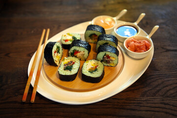 Sushi rolls with soy sauce. roll set sashimi japanese food on wooden background roll set sashimi japanese food on wooden background