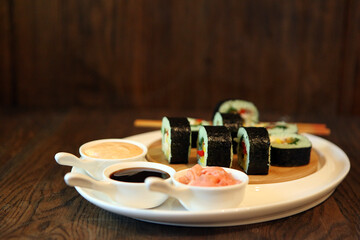 Fototapeta na wymiar hot roll set sashimi japanese food on wooden background