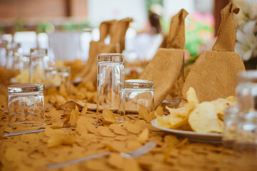 party table decorated with glasses and golden tablecloth