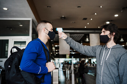 Sportsman going through temperature checkpoint at health club during pandemic