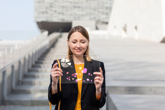 Female entrepreneur working over glass digital tablet outdoors