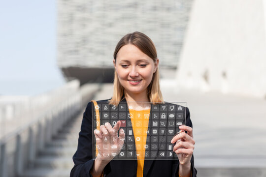 Smiling entrepreneur using futuristic digital tablet outdoors