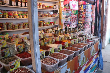 Spice market. Boxes of brightly colored spices. Turmeric, pepper, rosemary, curry, cinnamon and others