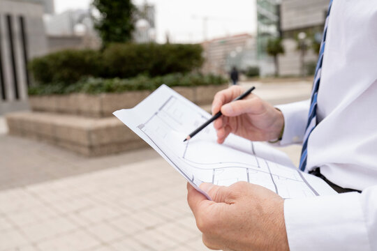 Male design professional working on blueprint