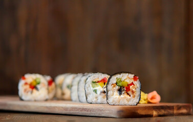 hot roll set sashimi japanese food on wooden background with lemon and chopsticks