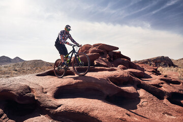 Fototapeta premium Mountain biker rides at the desert scenic in Kazakhstan