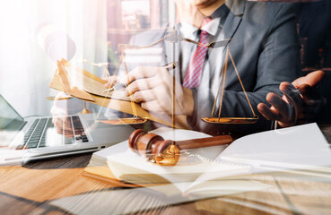 Justice and law concept.Male judge in a courtroom with the gavel, working with, computer and...