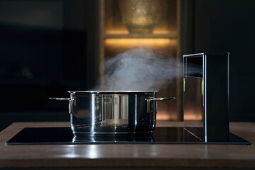 steaming pot with fume hood in kitchen;smell;food preparation;