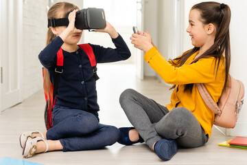 Studying in virtual reality. Modern technology. Interesting lesson. Virtual teaching. Homeschooling online. Girl kid study in virtual school. Virtual education. Child cute pupil wear hmd vr glasses.