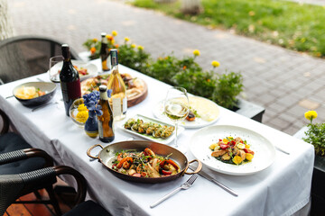 Served table at summer terrace restaurant with different dishes