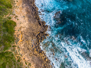 Aerial view of Alghero blue sea and rocky shore
