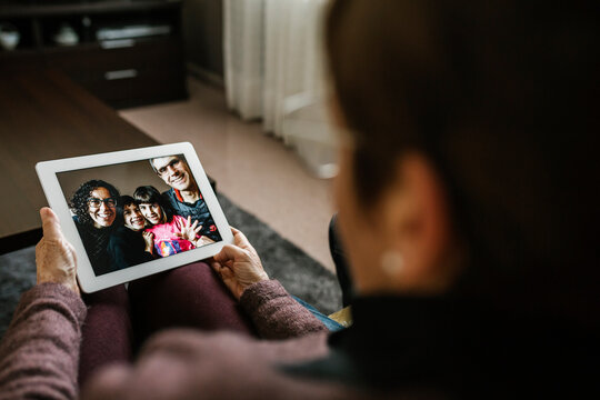 Senior woman on video call with family at home during COVID-19
