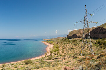 The southern shore of the Issyk Kul lake. Kyrgyzstan. The power line runs near the lake....