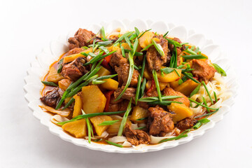Isolated stewed chicken roast with potatoes dish on the white