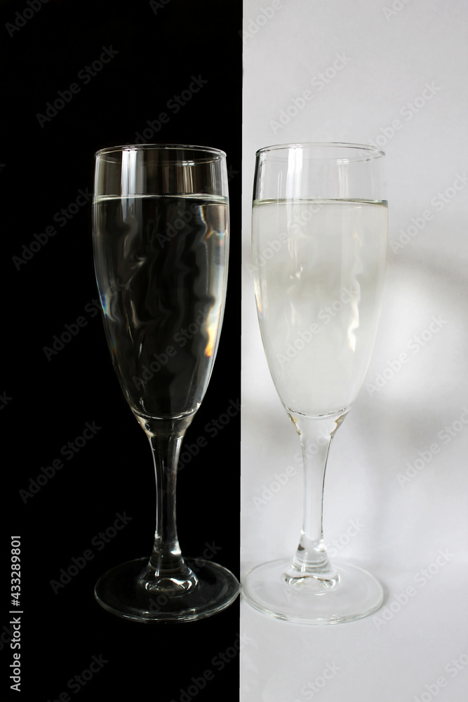 Wall mural glass glasses with water, black and white, two glasses, light and dark