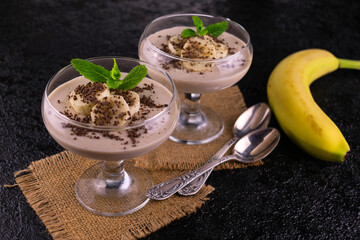 Two bananas chocolate musa on a black background.