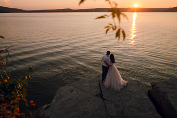 Fototapeta premium Sensual wedding couple groom and bride near the beautiful lake