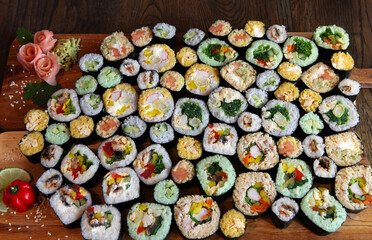 Sushi Set - Different Types of Maki Sushi and Nigiri Sushi. Served on dark wooden table.