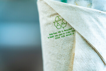 tissue on the coffee glass and the recycle sign and the words "Made from 100% Recycled fibers".