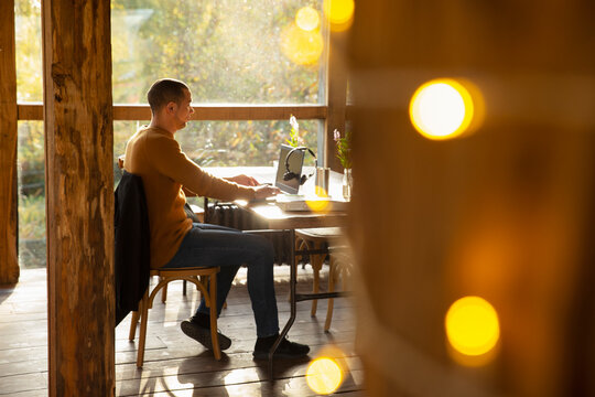 Businessman working at laptop at cafe table