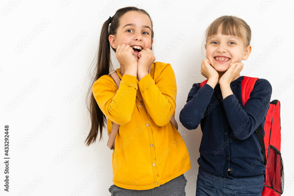 Wall mural two little girls show emotions. real emotions. nice smiling little girl,