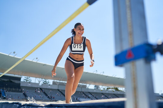 Female track and field athlete high jumping