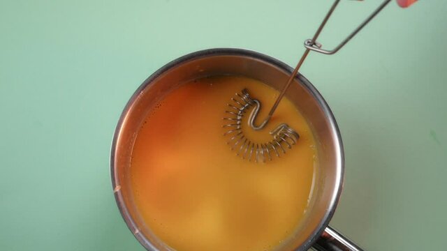 Pastry chef prepares citrus mousse for the filling in the cake. Process preparation desserts. Citrus jam 